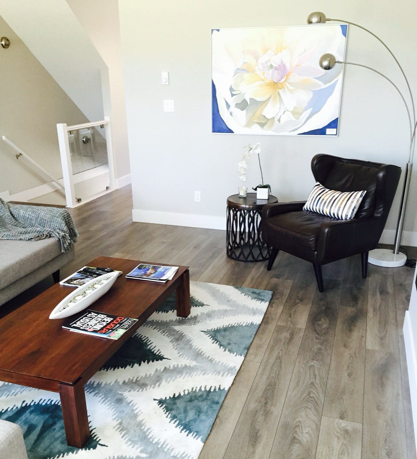 Bright living room with wide-plank engineered hardwood flooring installed by Showroom Designworks