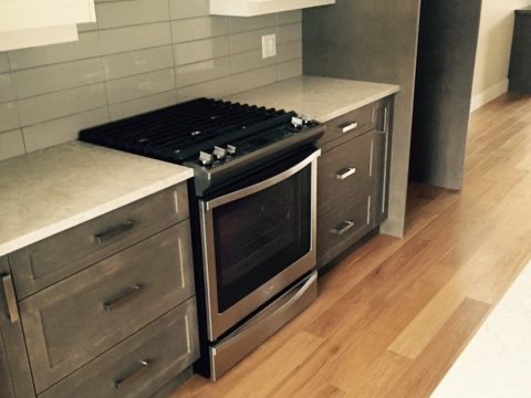 Kitchen range and cabinets over oak flooring