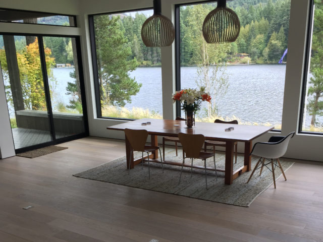 Dining area with lake view over pale hardwood