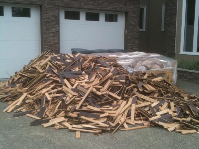 Hardwood boards racked out across a floor before installation