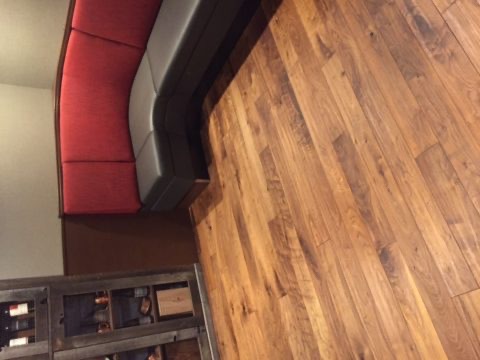 Restaurant booth seating on warm plank flooring