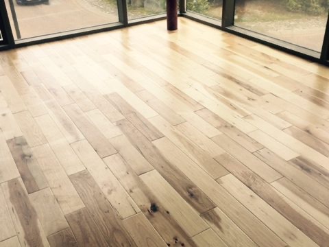Wide-plank hickory floor in a bright room
